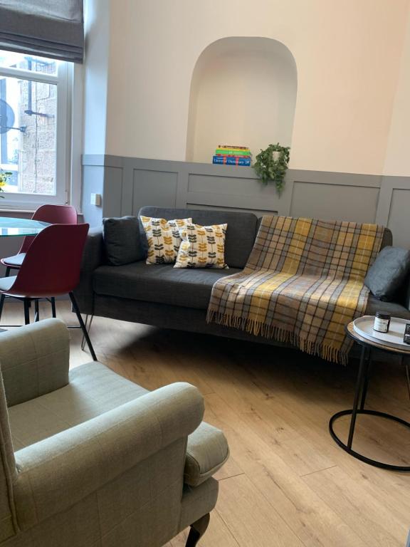 a living room with a couch and a table at DS Study or Visit in Dundee
