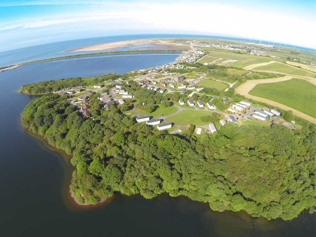 an aerial view of an island in the water at Plot 8 Lakeside Cabin, Wyldecrest, Millom in Millom