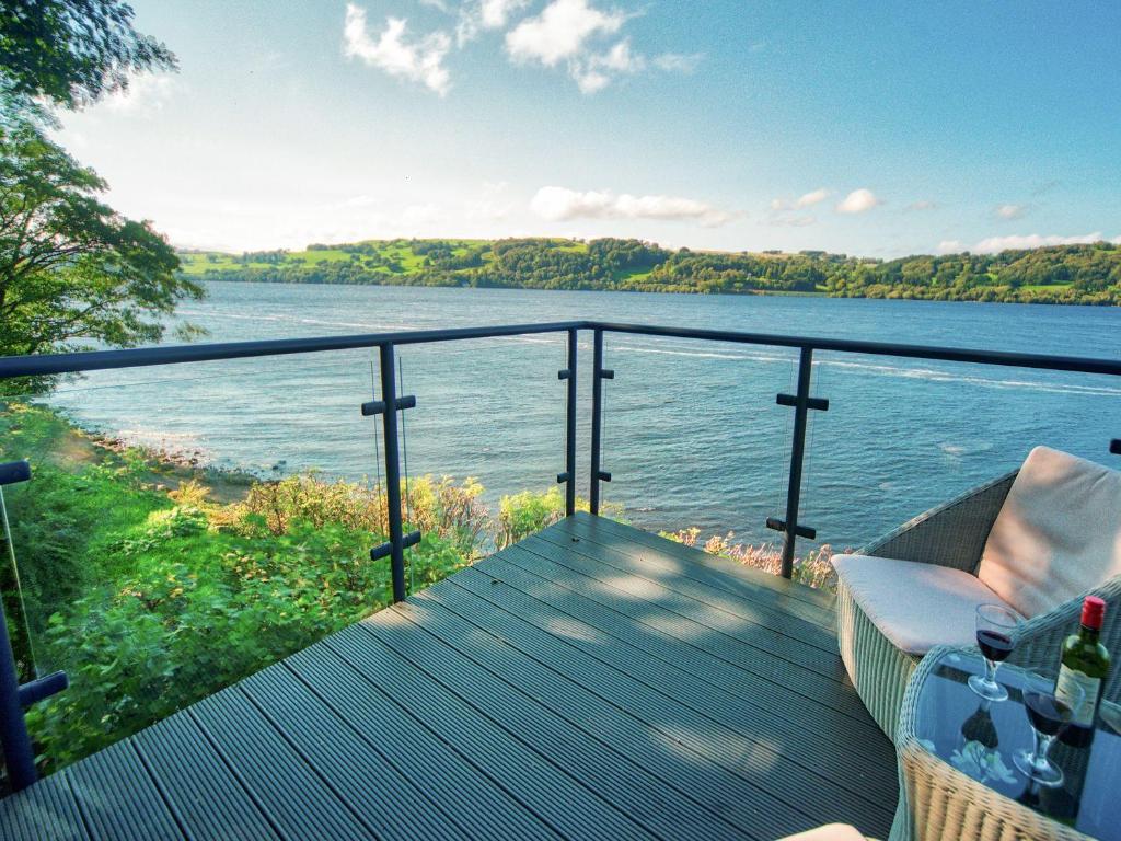 a balcony with a view of a body of water at Drysgol Lakeside - Bala Lake in Bala