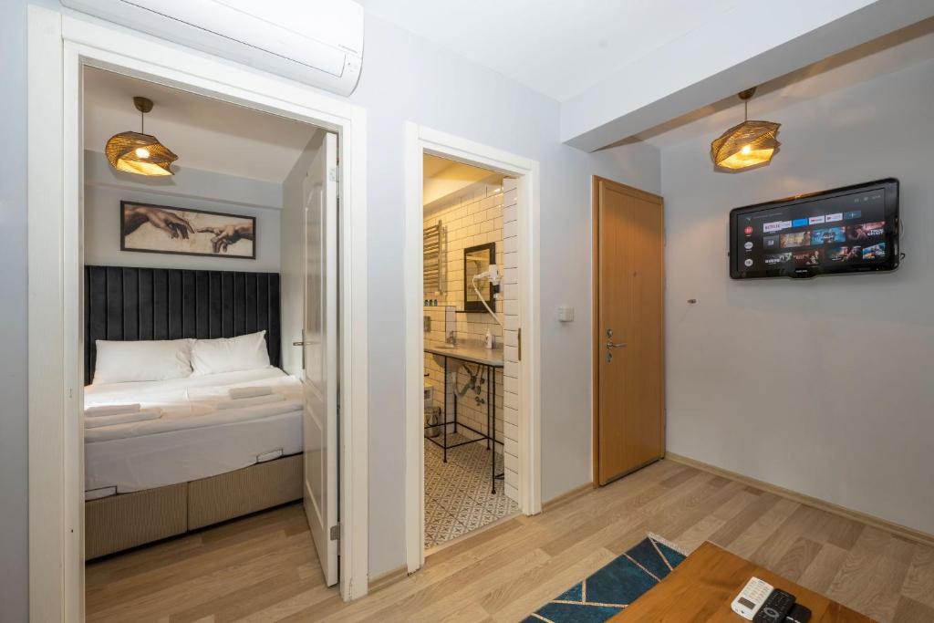 A bed or beds in a room at Dorne Suite Taksim Hotel