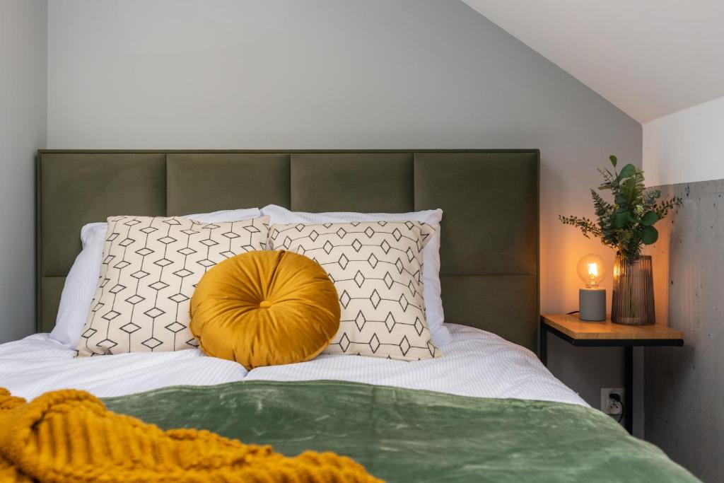 a bed with a large pillow on top of it at Felicjanek 15 - by Upstairs in Kraków