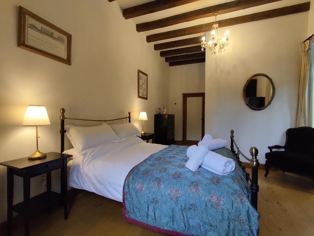 a bedroom with a bed with a teddy bear on it at Château de Chauvac - Chambres et table d'hôtes avec vue sur la rivière in Bassignac-le-Bas