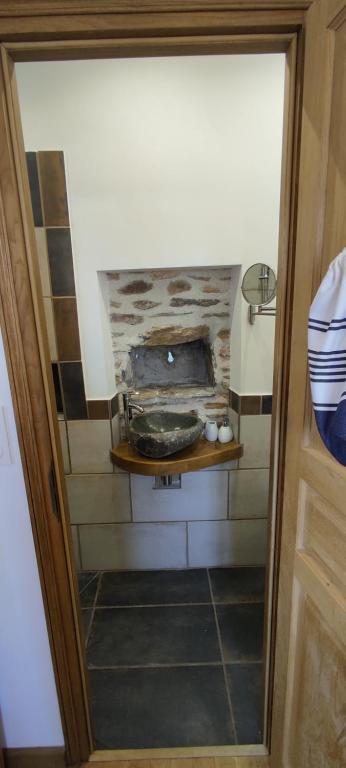a room with a stove in the corner of a room at Château de Chauvac - Chambres et table d'hôtes avec vue sur la rivière in Bassignac-le-Bas