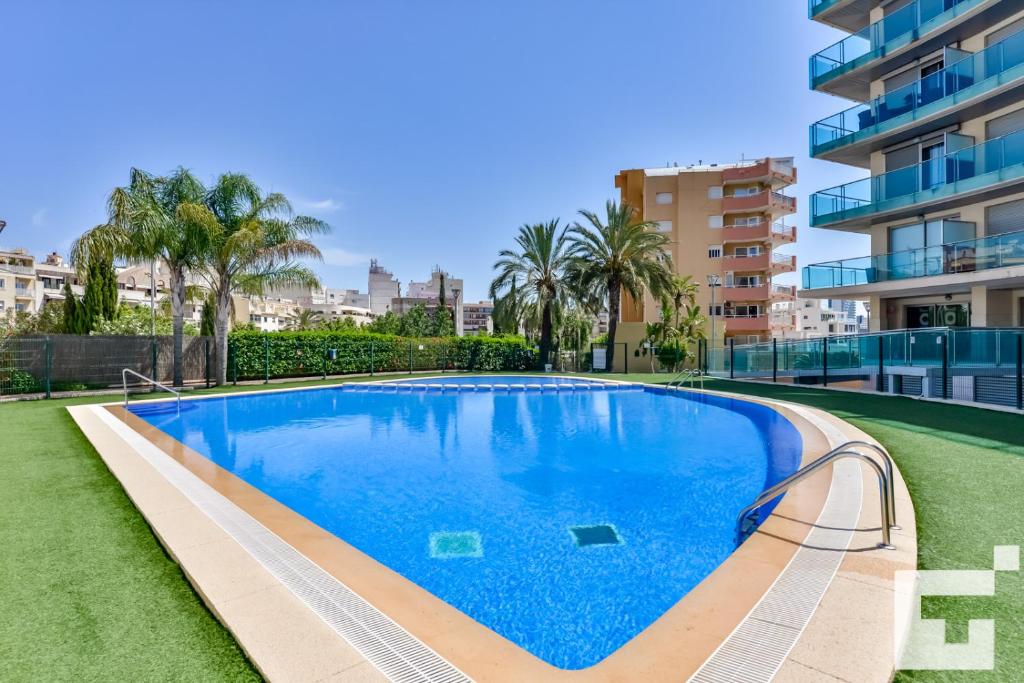 a swimming pool in front of a building at Apartamento Borumbot 26 - Grupo Turis in Calpe