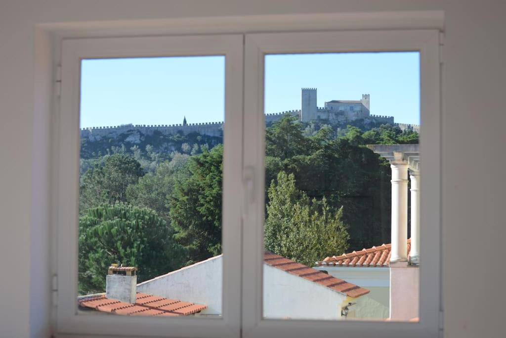 an open window with a view of a building at Casa da Várzea - O Castelo à Janela!!! in Óbidos