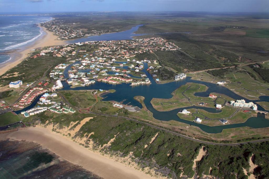 an aerial view of a town next to a body of water at Marina Martinique B&B in Jeffreys Bay