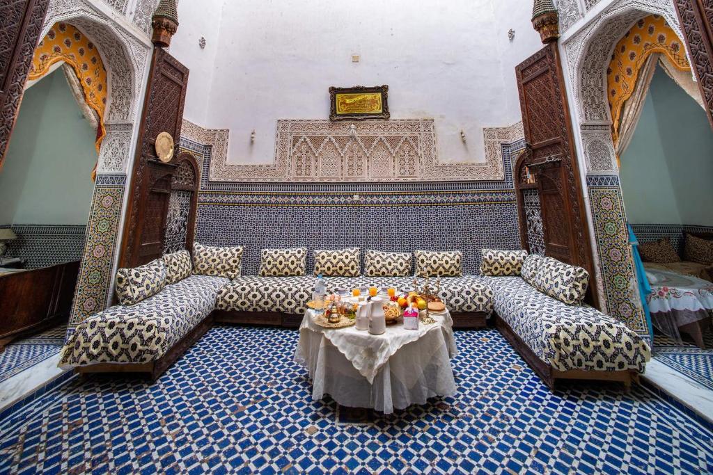 a room with a couch and a table with fruit on it at Dar El Arfaoui in Fez