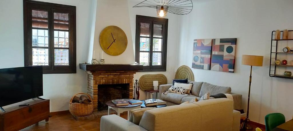 a living room with a couch and a fireplace at LOS SUEÑOS DE BUENDÍA in Buendía