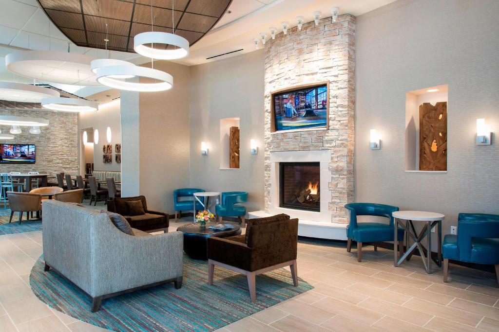 a waiting room with chairs and a fireplace at Residence Inn by Marriott Ann Arbor Downtown in Ann Arbor