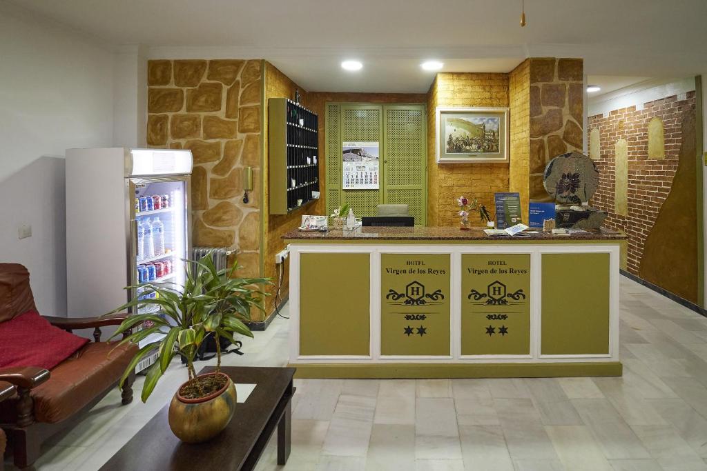 a kitchen with a counter and a refrigerator at Hotel Virgen de los Reyes in Ronda