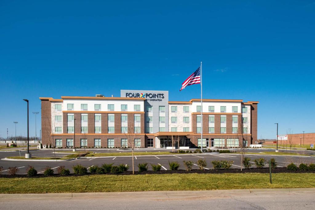 a building with an american flag on top of it at Four Points by Sheraton Kansas City Olathe in Olathe