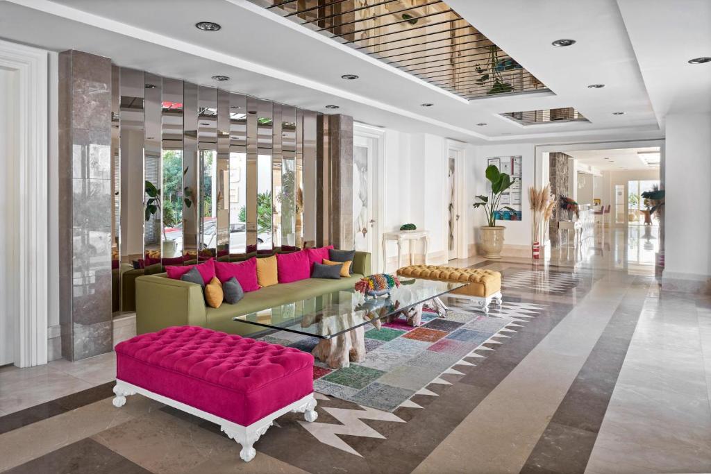 a living room with a couch and a table at Prive Hotel Bodrum - Adult Only in Bodrum City