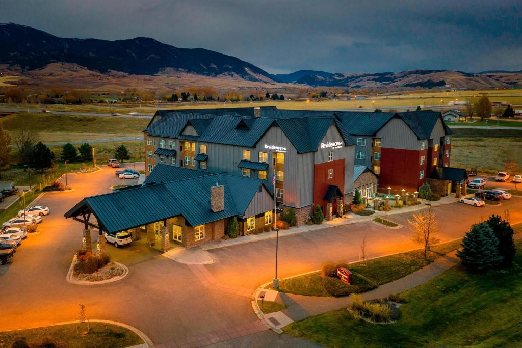 an aerial view of a large building with a parking lot at Residence Inn Bozeman in Bozeman