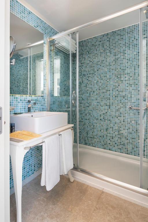 a bathroom with a tub and a sink and a shower at Prive Hotel Bodrum - Adult Only in Bodrum City