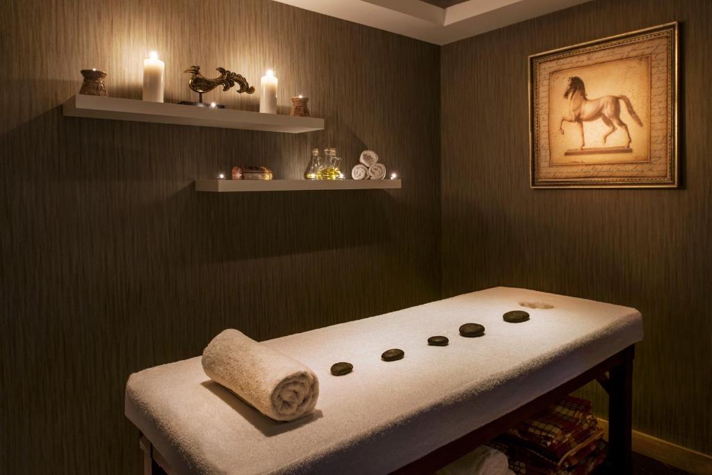 a room with a bench with a towel and candles at Prive Hotel Bodrum - Adult Only in Bodrum City