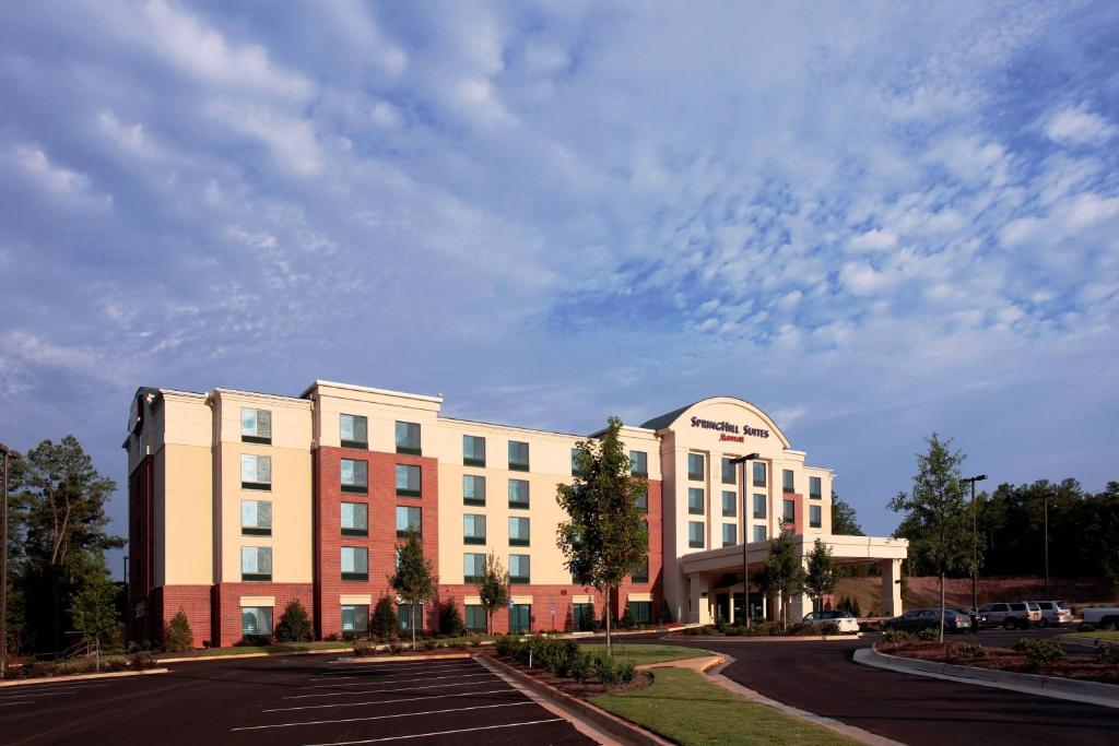 a large building with a parking lot in front of it at SpringHill Suites by Marriott Athens West in Athens