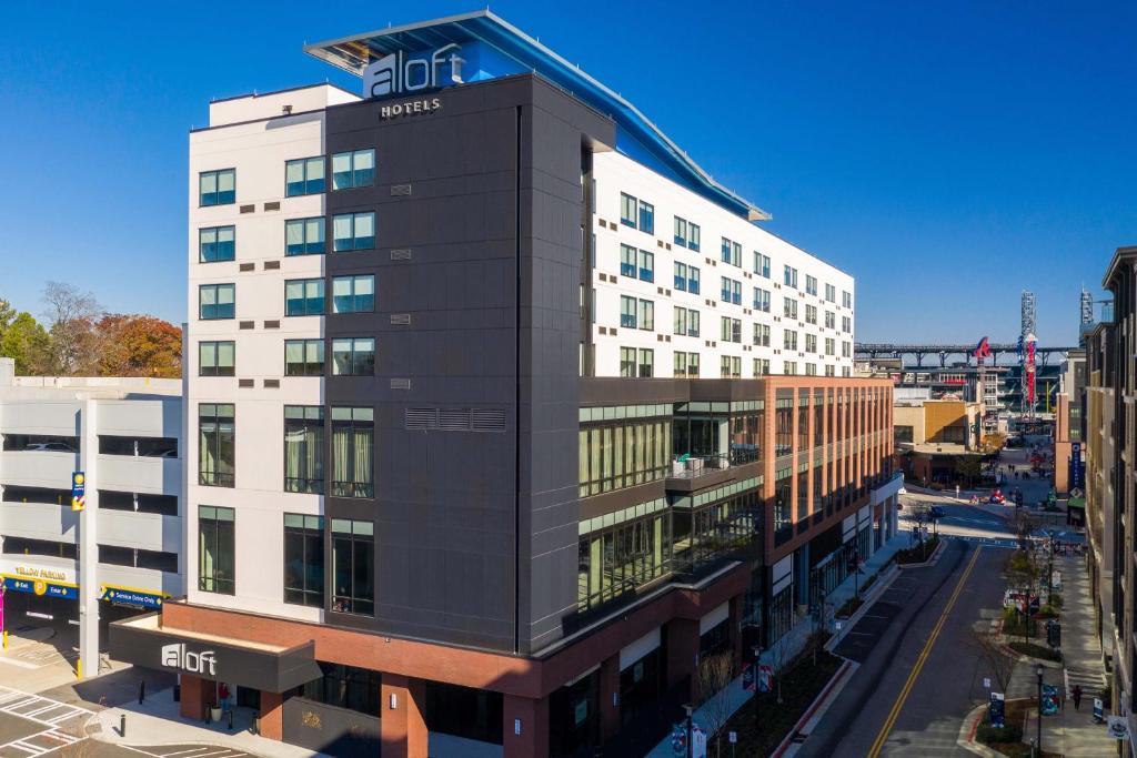 an office building with a sign on top of it at Aloft Atlanta at The Battery Atlanta in Atlanta