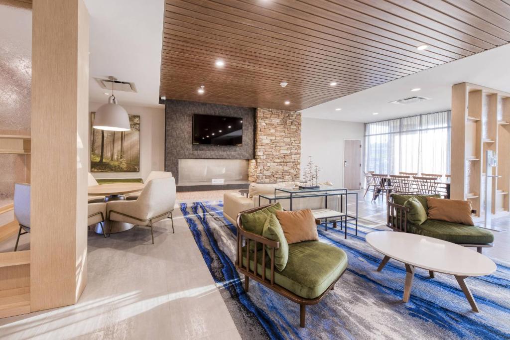 a living room with couches and a dining room at Fairfield Inn & Suites by Marriott Charlotte Belmont in Belmont