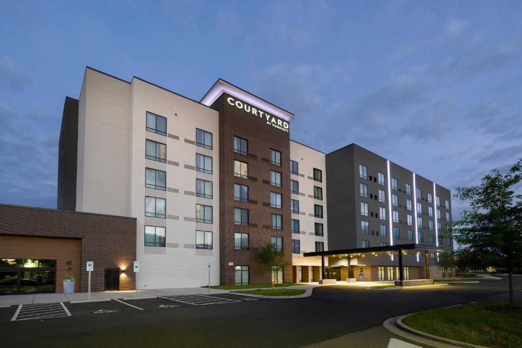 a rendering of a hotel building with a parking lot at Courtyard by Marriott Charlotte Waverly in Charlotte