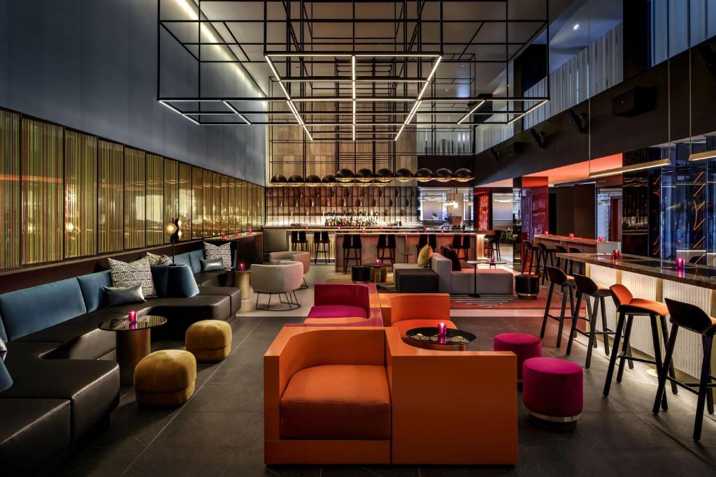 a lobby with couches and chairs and a bar at W Montreal in Montreal