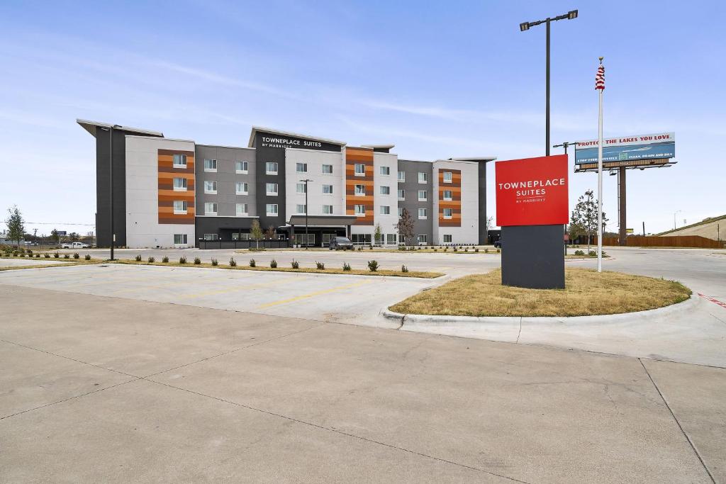 韋科的住宿－TownePlace Suites Waco Northeast，停车场里红色标志的建筑