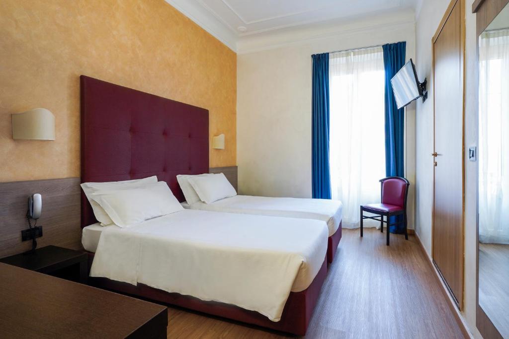 Postel nebo postele na pokoji v ubytování Hotel Panizza