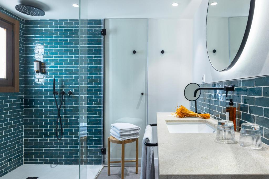 a bathroom with a sink and a glass shower at Samaritana Suites in Palma de Mallorca