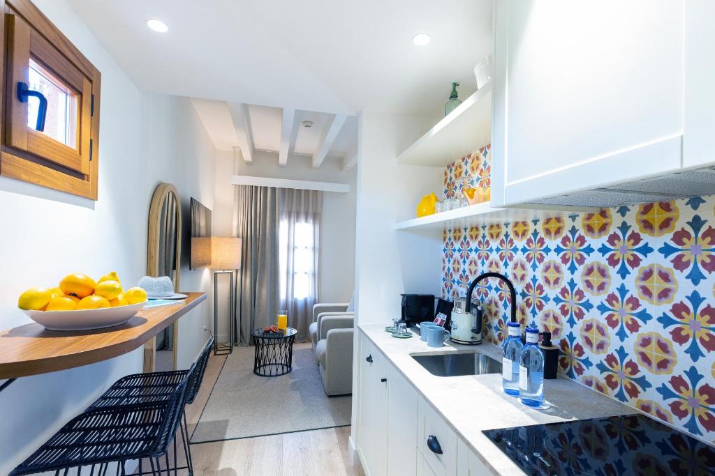 a kitchen with a sink and a counter top at Samaritana Suites in Palma de Mallorca