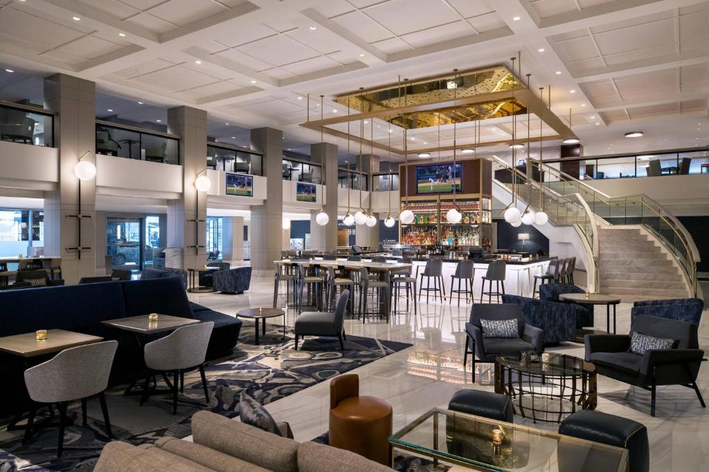 a lobby with tables and chairs and a bar at Chicago Marriott Downtown Magnificent Mile in Chicago