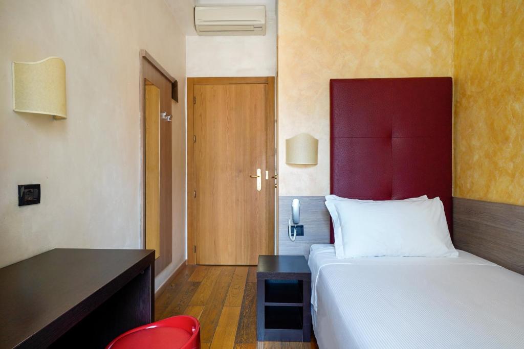 Postel nebo postele na pokoji v ubytování Hotel Panizza