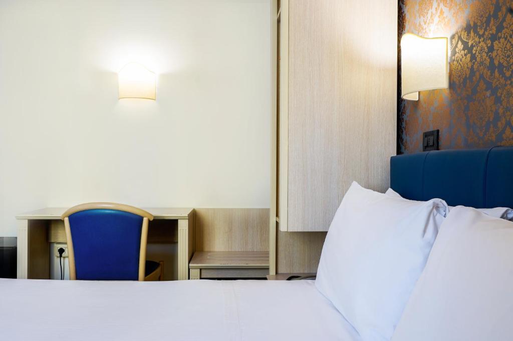 Postel nebo postele na pokoji v ubytování Hotel Panizza