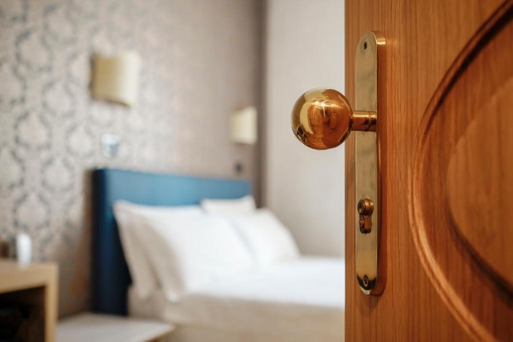Postel nebo postele na pokoji v ubytování Hotel Panizza