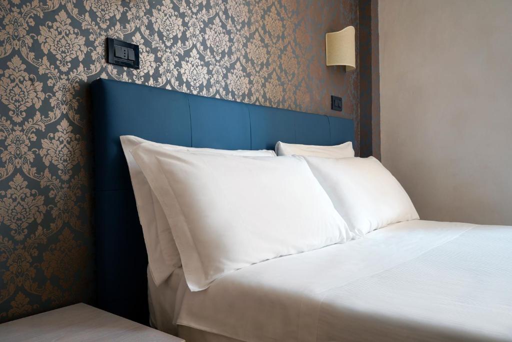 Postel nebo postele na pokoji v ubytování Hotel Panizza
