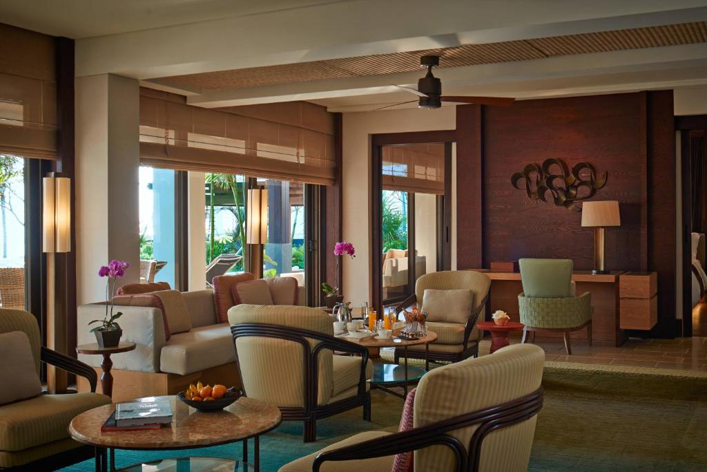 a lobby with chairs and tables and a living room at The Ritz-Carlton Bali in Nusa Dua
