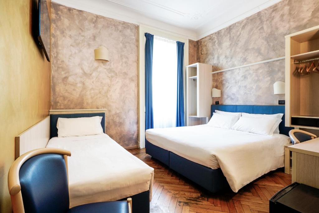 Postel nebo postele na pokoji v ubytování Hotel Panizza