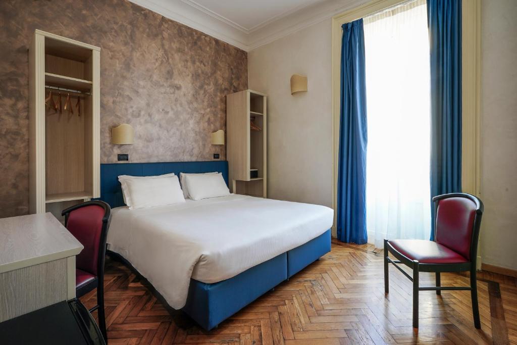 Postel nebo postele na pokoji v ubytování Hotel Panizza