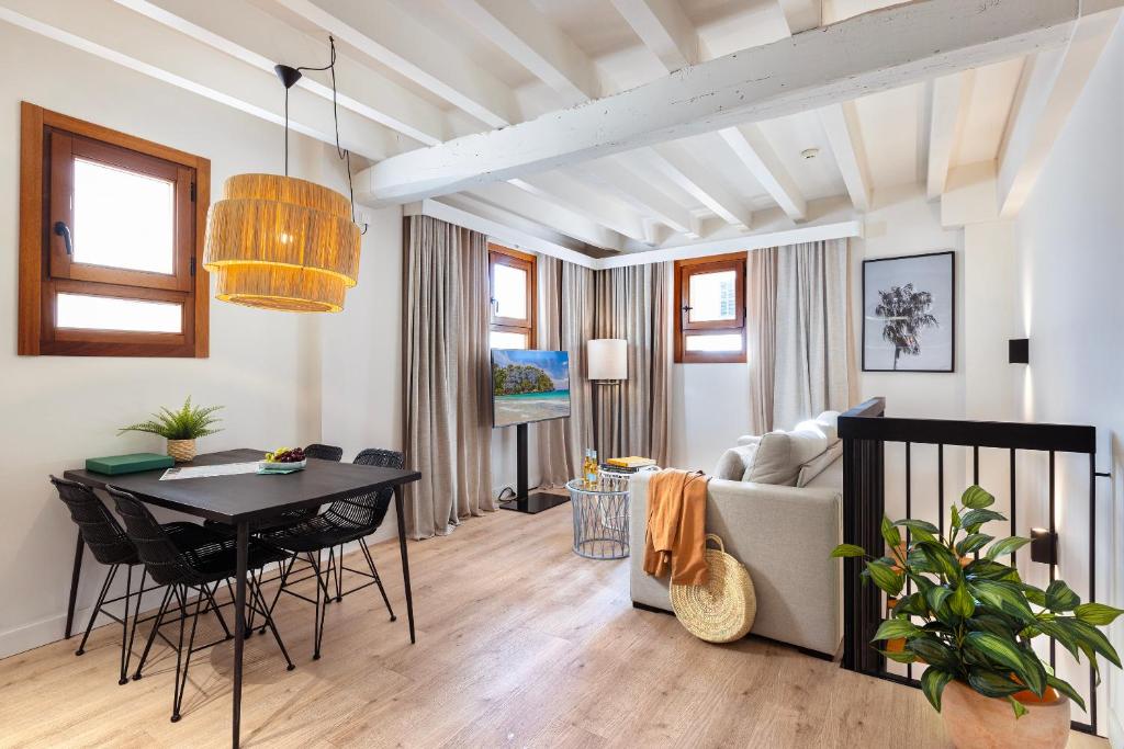 a living room with a table and a couch at Samaritana Suites in Palma de Mallorca