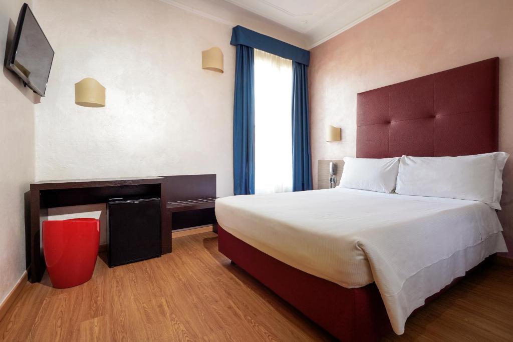 Postel nebo postele na pokoji v ubytování Hotel Panizza