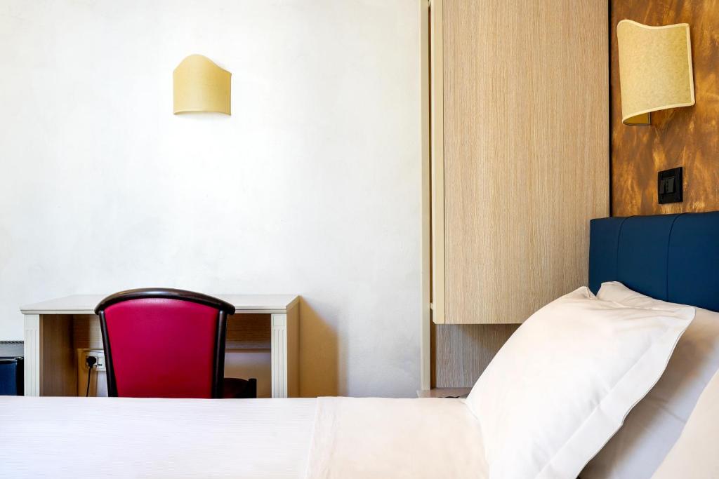 Postel nebo postele na pokoji v ubytování Hotel Panizza