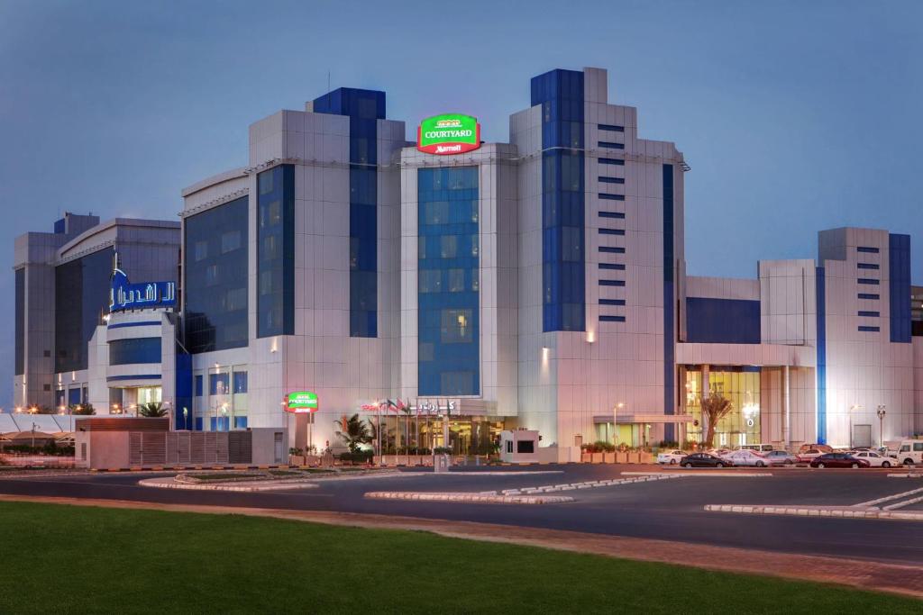 a large building with a sign on top of it at Courtyard by Marriott Jazan in Jazan