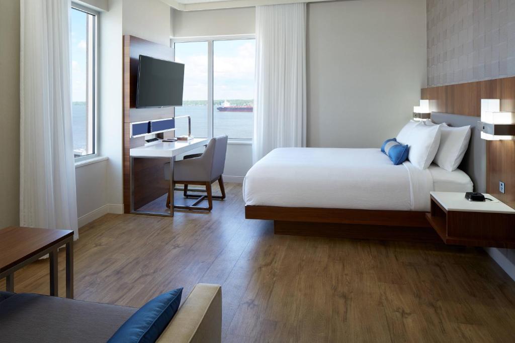 una camera d'albergo con letto, scrivania e TV di Delta Hotels by Marriott Trois Rivieres Conference Centre a Trois-Rivières
