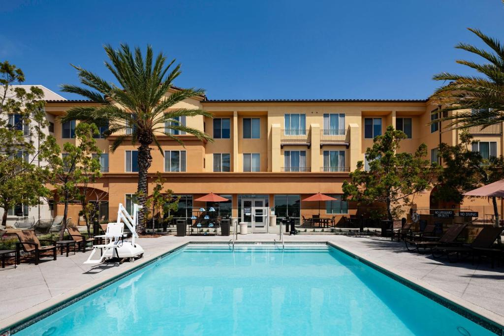 a hotel with a swimming pool in front of a building at Residence Inn by Marriott San Juan Capistrano in San Juan Capistrano