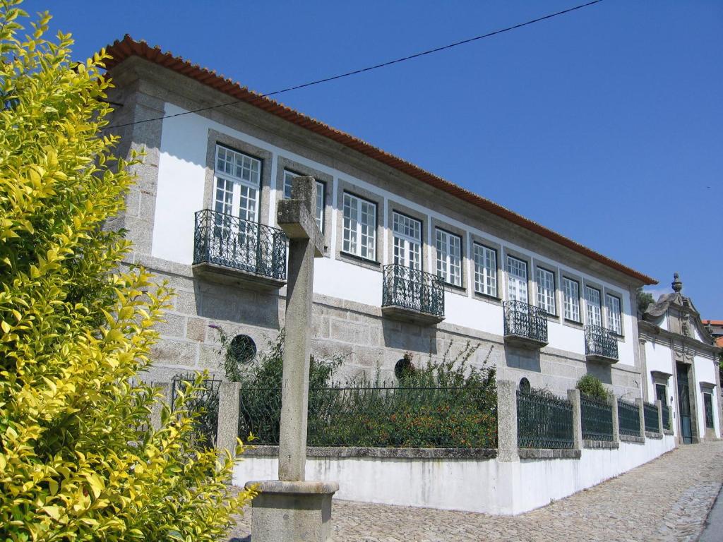 a building with windows and balconies on a street at Casa De Alfena in Póvoa de Lanhoso