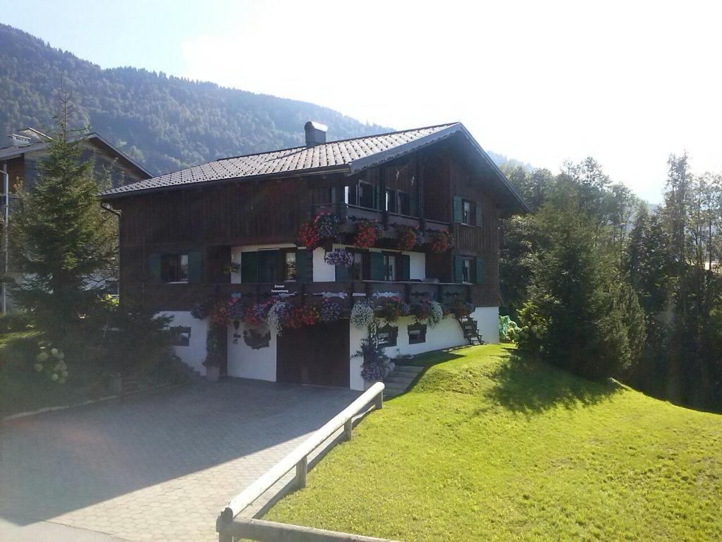 a house with flowers on the front of it at Apartment Jaegerhaus in Andelsbuch