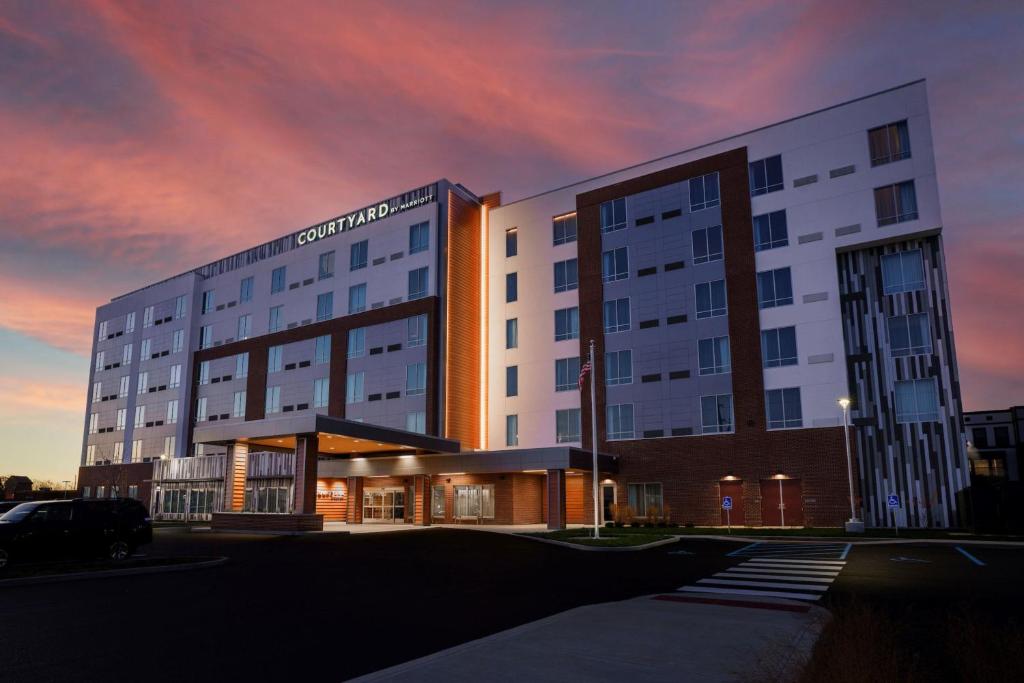 a large building with a parking lot in front of it at Courtyard by Marriott Indianapolis Fishers in Fishers