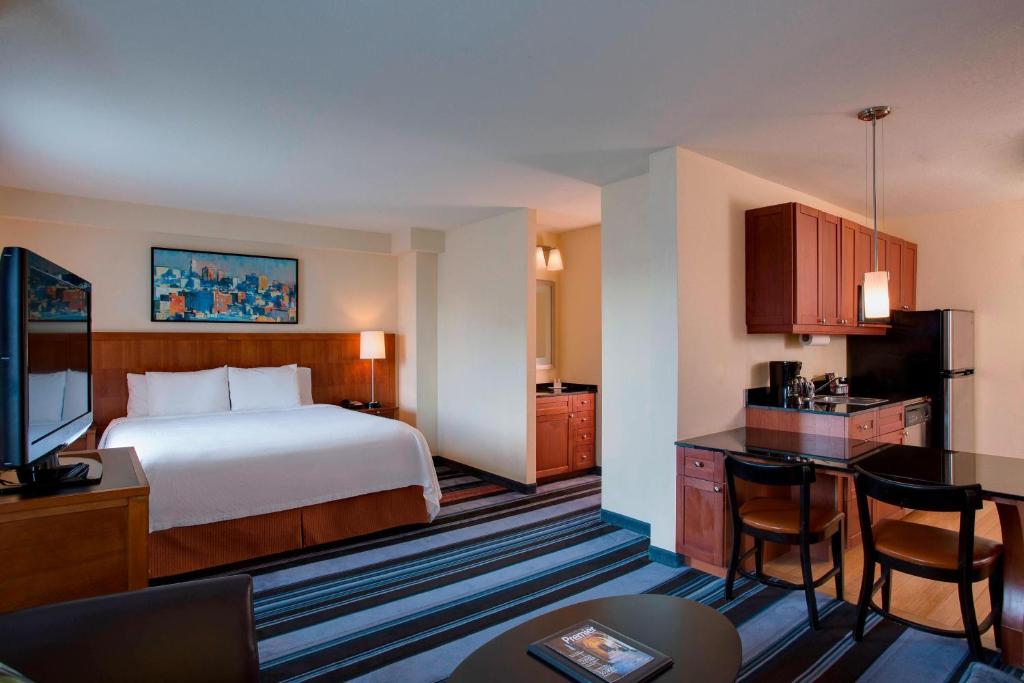 a hotel room with a bed and a kitchen at Residence Inn by Marriott New York Manhattan/Times Square in New York