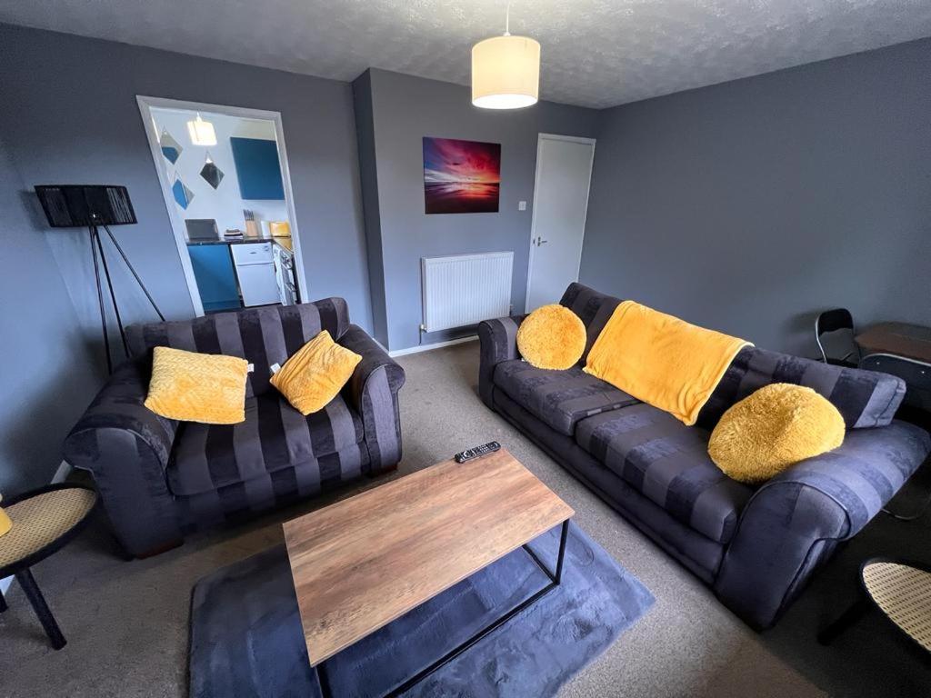 a living room with two couches and a coffee table at Spacious Apartment with Parking in Norwich