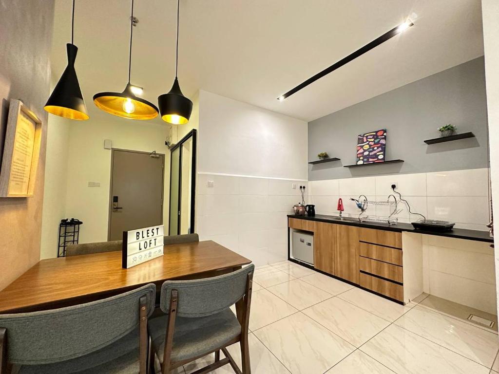 a kitchen with a table and chairs and a counter at Blest Loft 12 Manhattan Suites ITCC in Penampang
