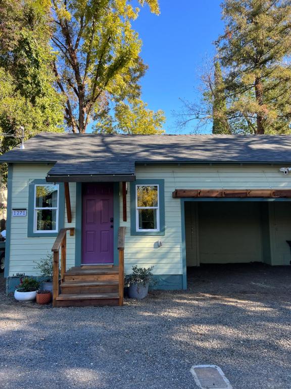 a small house with a purple door and a porch at Citrus Studio A in Chico