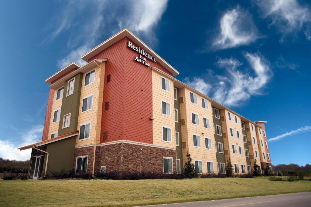 a large building with a red and white at Residence Inn by Marriott Florence in Florence